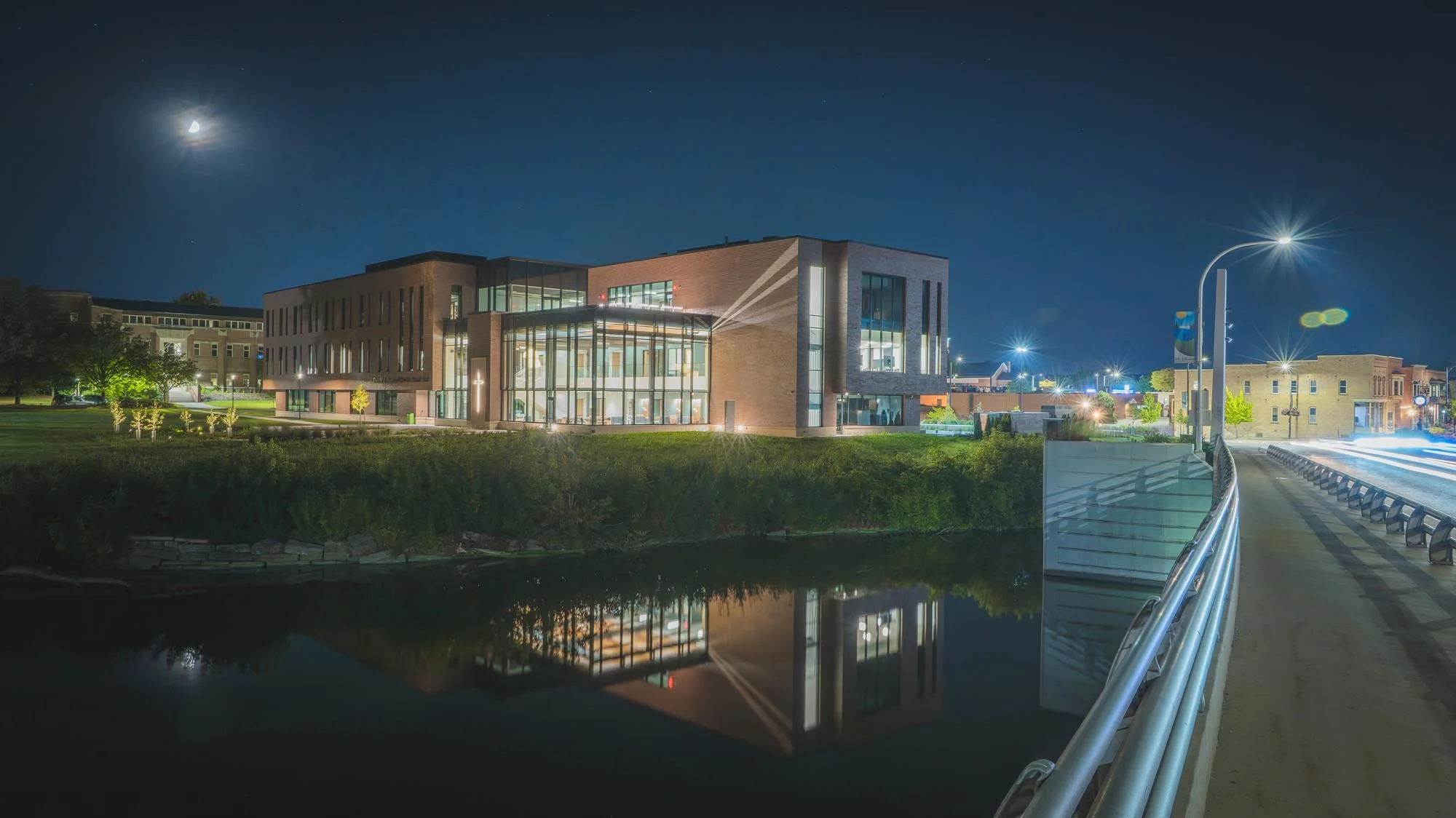 Schneider Family Hall at St. Norbert College beside the Fox River at night